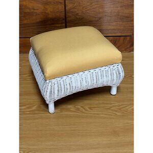 Vintage white wicker footstool with upholstered cushion